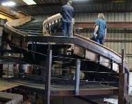 Inside of the hull is a bent steel frame forming the structure of the stairway. None of the steel will be visible. In this image, there is a lot of support structure shown that will not be in the final assembly