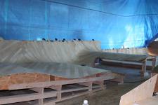 Four layers of strakes are installed with each layer 45 degrees to the last. The building method is called cold-molding and is a technique borrowed from high end yacht hull building