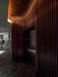 There is a glow of light coming from the ceiling where a valance is used to hide the lights. Light flows onto the most strongly contoured portion of the wall to highlight the dramatic curves